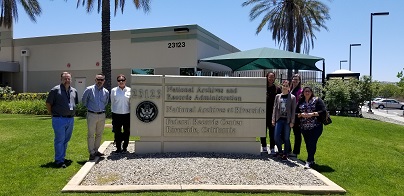 NARA Librarians and CARLDIG-S Visitors Stand in Front of Sign